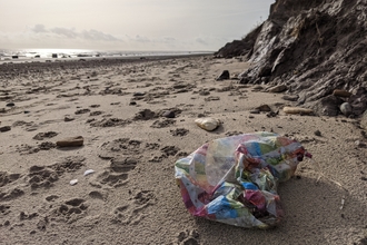 beach litter strewn across a beach.