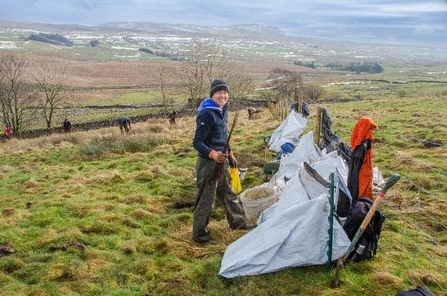 woman in field in the Dales doing practical tasks