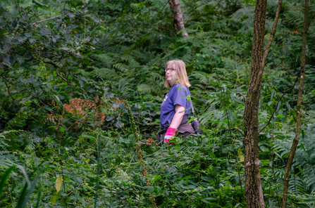 Low Wood volunteer in undergrowth 