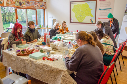 People needle felting around a table