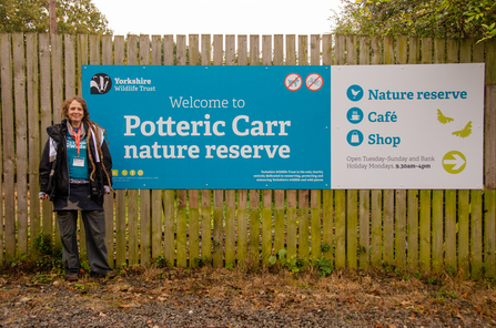 YWT's Sarah standing in front of the welcome sign at Potteric Carr