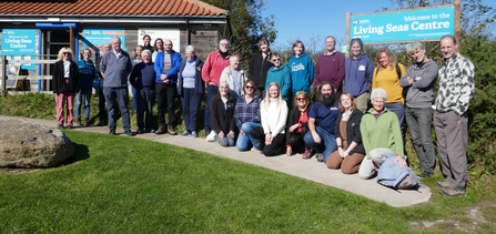 Group shot of marine volunteers standing outside the Living Seas Centre