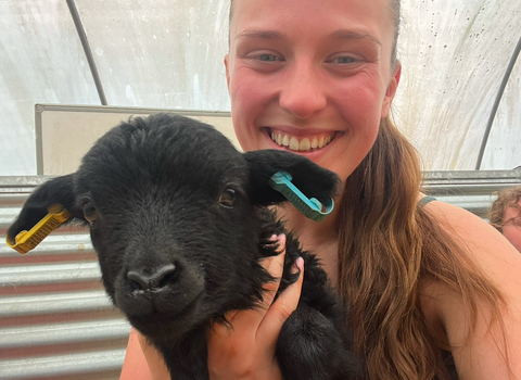 Trainee Savannah holding a lamb